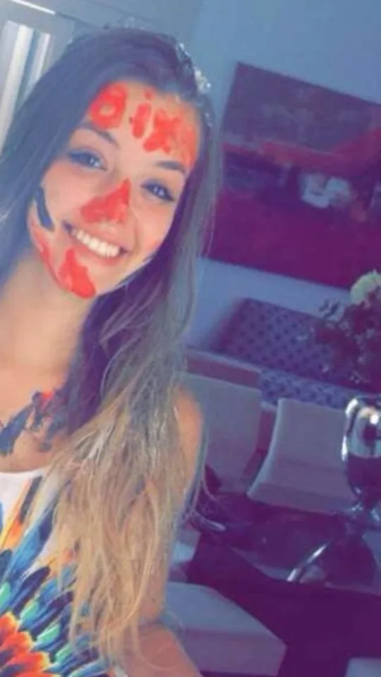 Letícia em 2016, caloura, sorrindo com o rosto pintado de vermelho no trote